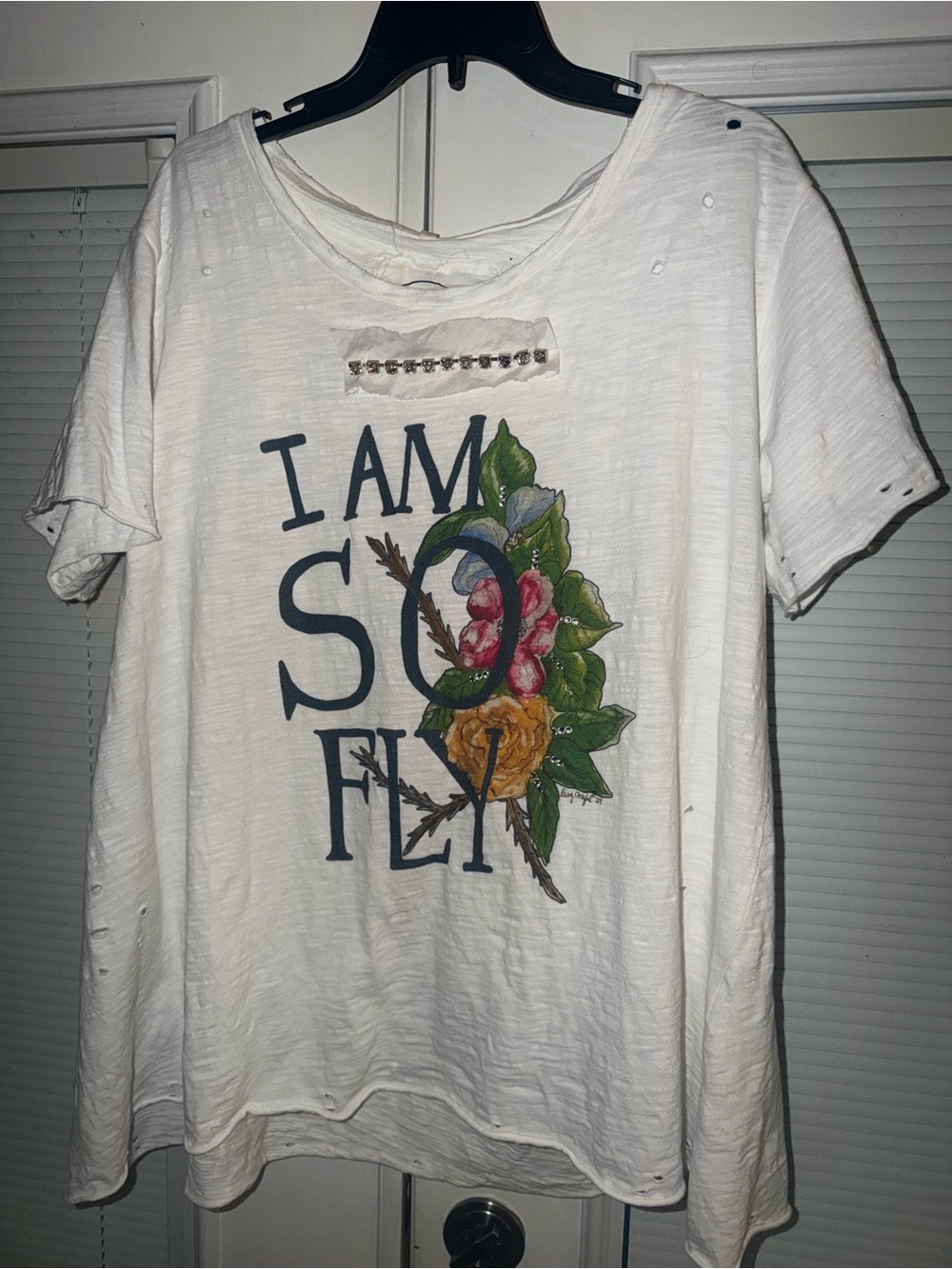 A Rare Bird Signature White Graphic Tee "I Am So Fly" with Floral Accent